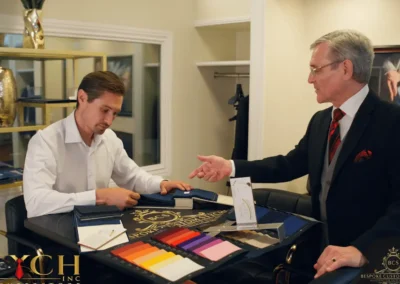 Tailor and client selecting fabrics in showroom at Stych Inc, Oxnard bespoke tailor in Ventura County.