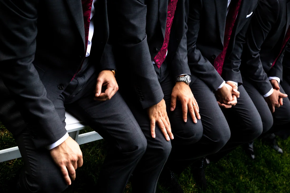 Groomsmen wearing coordinated dark suits at a wedding