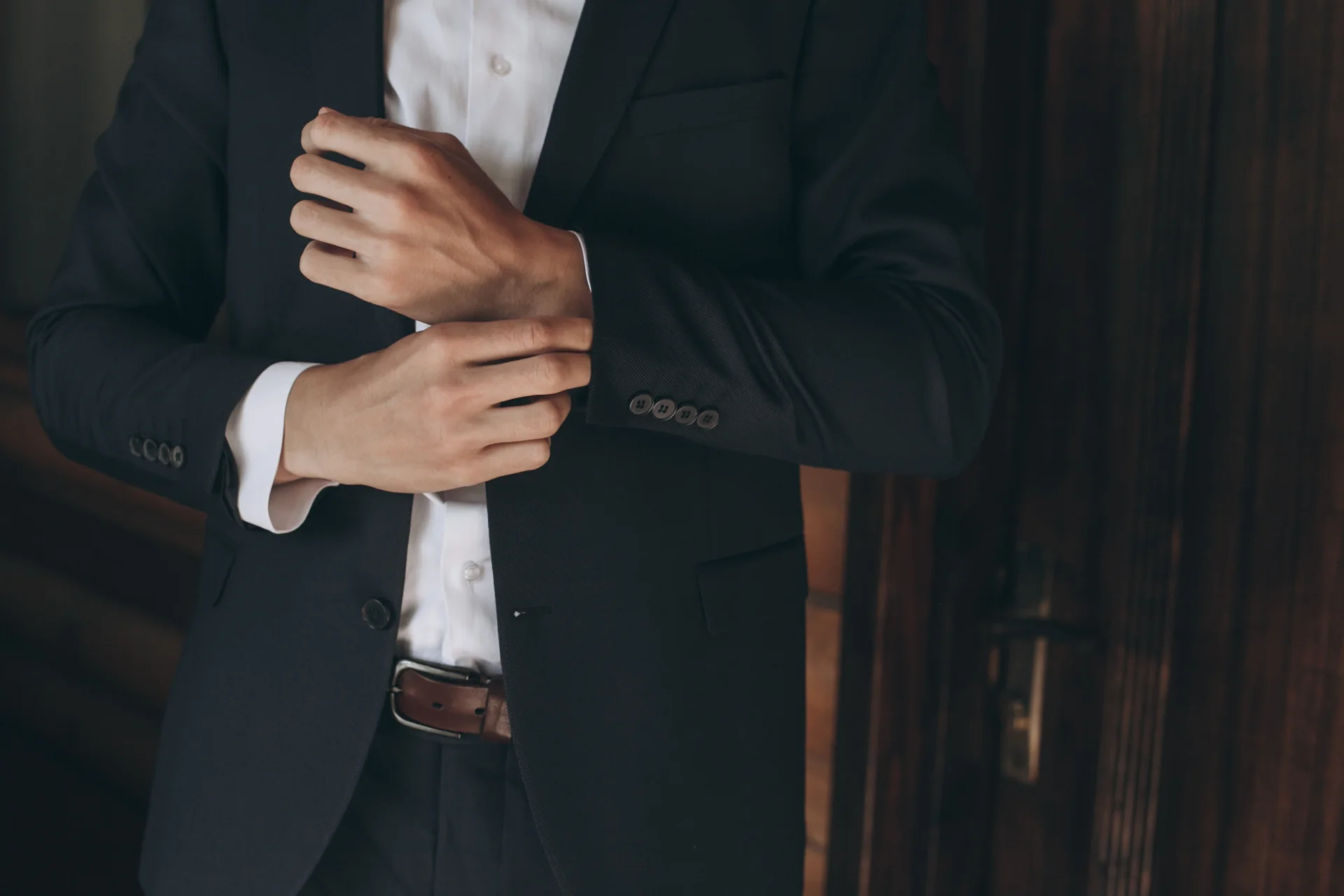Man wearing a dark suit with a white dress shirt for cocktail attire
